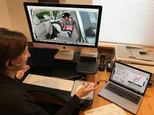 Child Passenger Safety Technician sitting at a desk conducting a virtual car seat check